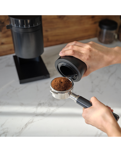 Fellow Grinder Opus Matte Black Pouring coffee grounds into portafilter