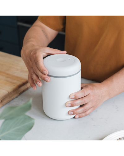 Fellow Atmos Canister 1.2L Matte White person twisting atmos lid