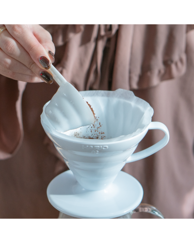 Hario V60 Plastic Dripper 02 White Pouring coffee grounds.
