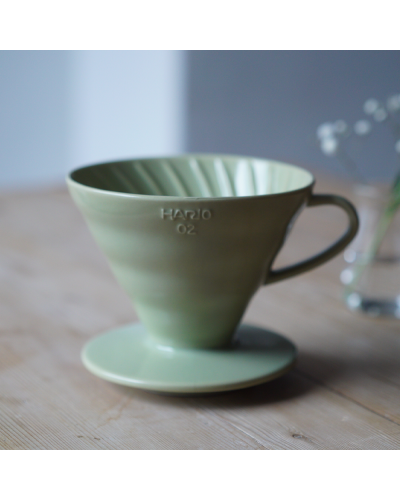 Hario V60 Dripper Cerámica 02-  Verde Pastel encima de mesa con flores