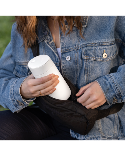 Fellow Carter Slide Mug 12oz Matte White inside a backpack