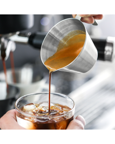 MHW3Bomber Stainless Steel Measuring Cup 100ml pouring into ice coffee.