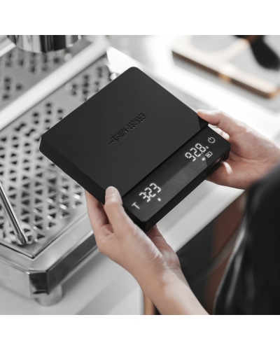 MHW3Bomber Cube Coffee Scale 3.0 Pro Max Black in hands of barista.