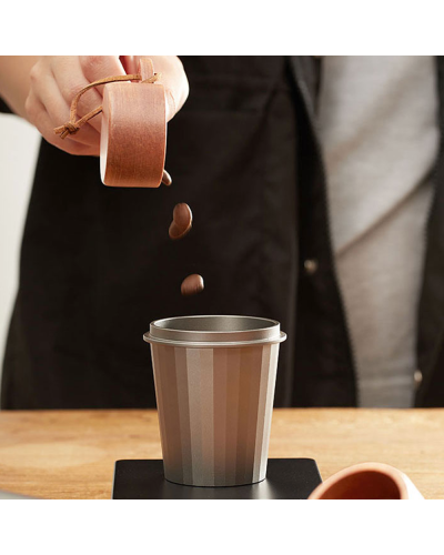 Using wooden Coffee measuring spoon with dosing cup.