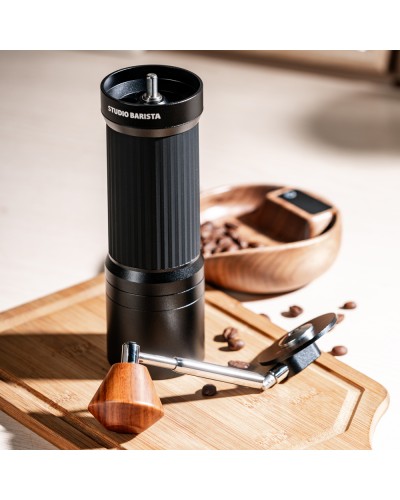 Studio Barista Manual Coffee Grinder with Foldable Handle Black on table